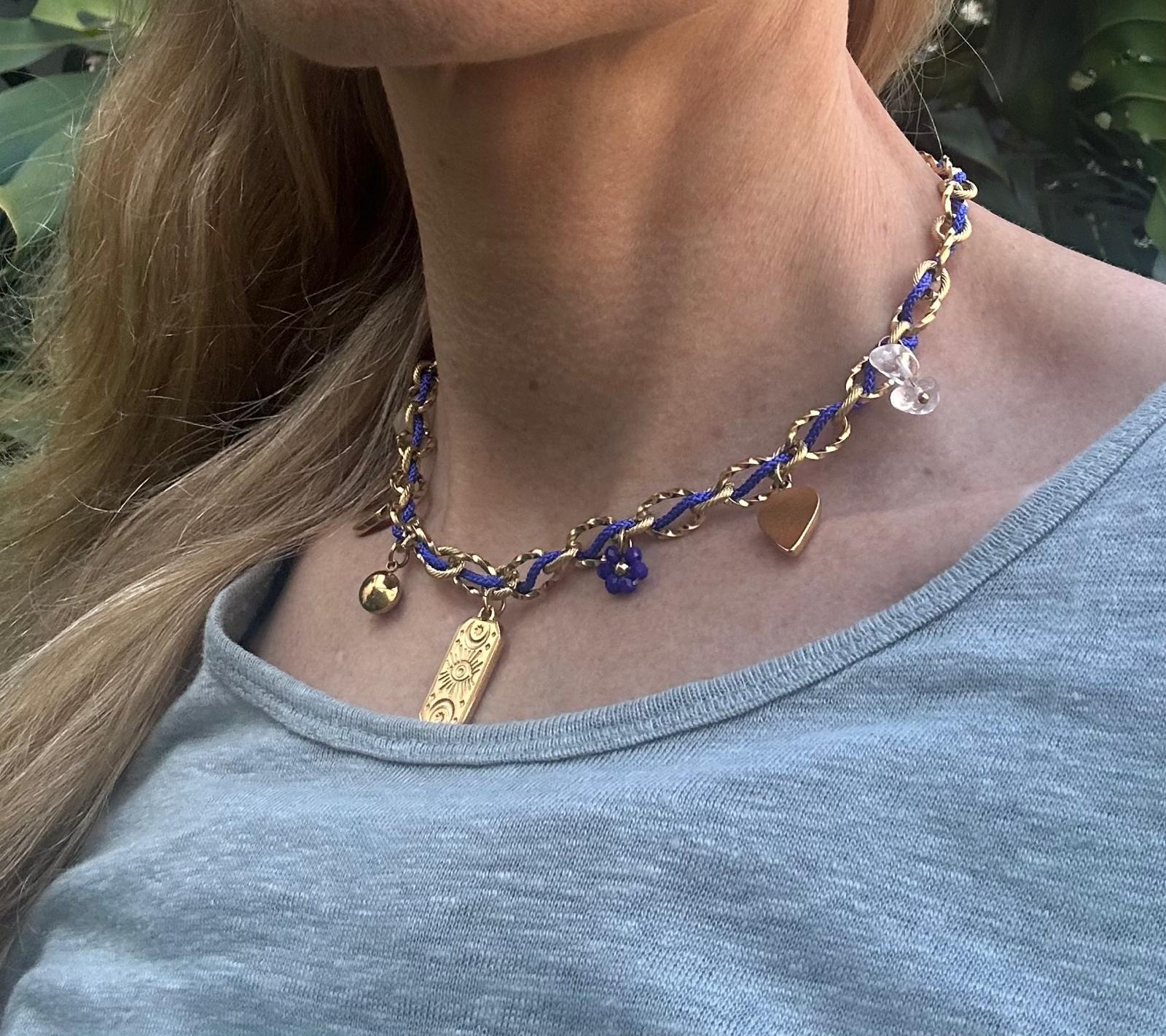 The Pandora Necklace blue and gold charm necklace | Handmade blue and gold necklace with delicate charms | Elegant gold chain necklace with blue accents | Artisan charm necklace for everyday wear | Luxury handmade necklace close up detail | Blue and gold necklace worn on neckline | Minimalist charm necklace with gold tones | Fashion jewelry necklace with blue detailing | Layering necklace blue and gold design | Modern handmade charm necklace | Statement necklace with gold and blue charms 