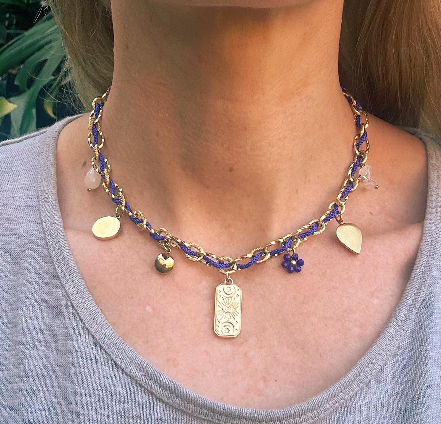 The Pandora Necklace blue and gold charm necklace | Handmade blue and gold necklace with delicate charms | Elegant gold chain necklace with blue accents | Artisan charm necklace for everyday wear | Luxury handmade necklace close up detail | Blue and gold necklace worn on neckline | Minimalist charm necklace with gold tones | Fashion jewelry necklace with blue detailing | Layering necklace blue and gold design | Modern handmade charm necklace | Statement necklace with gold and blue charms |