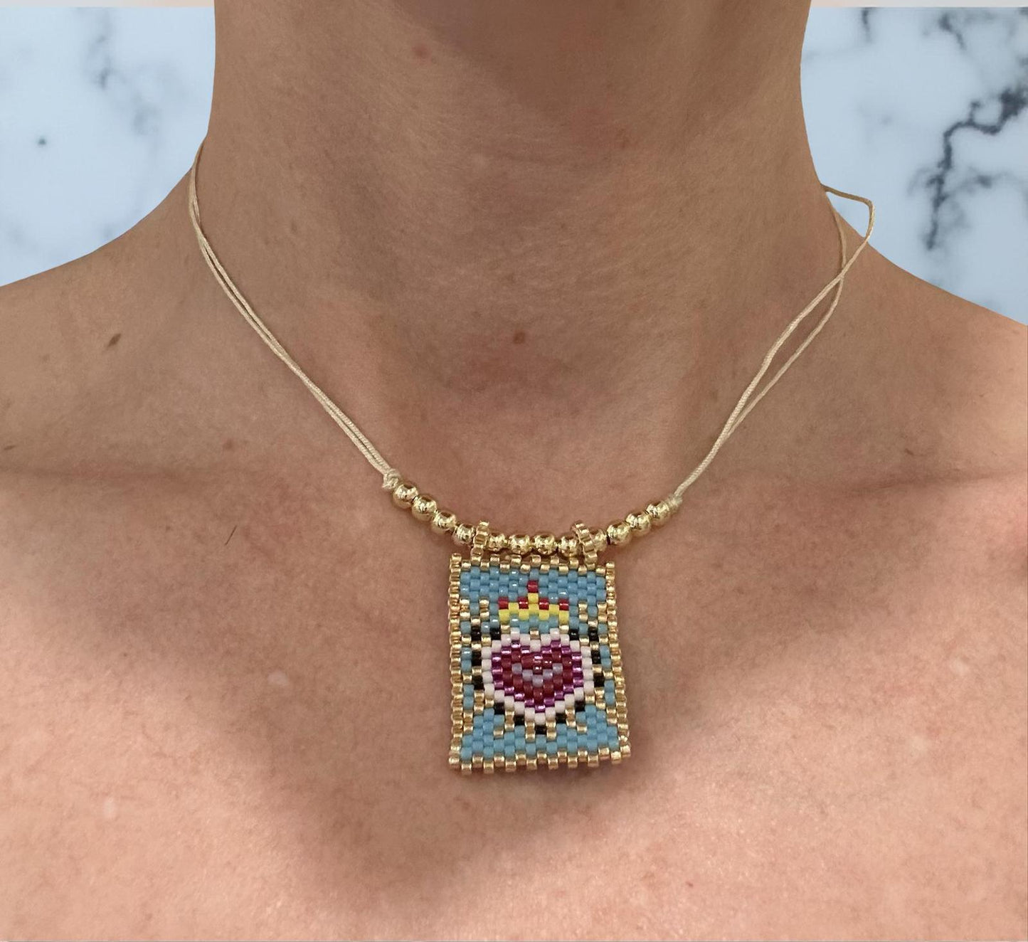 handwoven golden beaded heart pendant necklace | handmade heart pendant necklace | golden beaded heart necklace | handwoven beaded jewelry necklace | heart pendant beaded necklace | handmade golden bead necklace | minimalist heart necklace gold | handcrafted beaded heart jewelry | lightweight heart pendant necklace | elegant golden heart necklace | artisan beaded necklace | heart charm beaded necklace | handmade gift heart necklace | boho beaded heart pendant | unique handwoven necklace